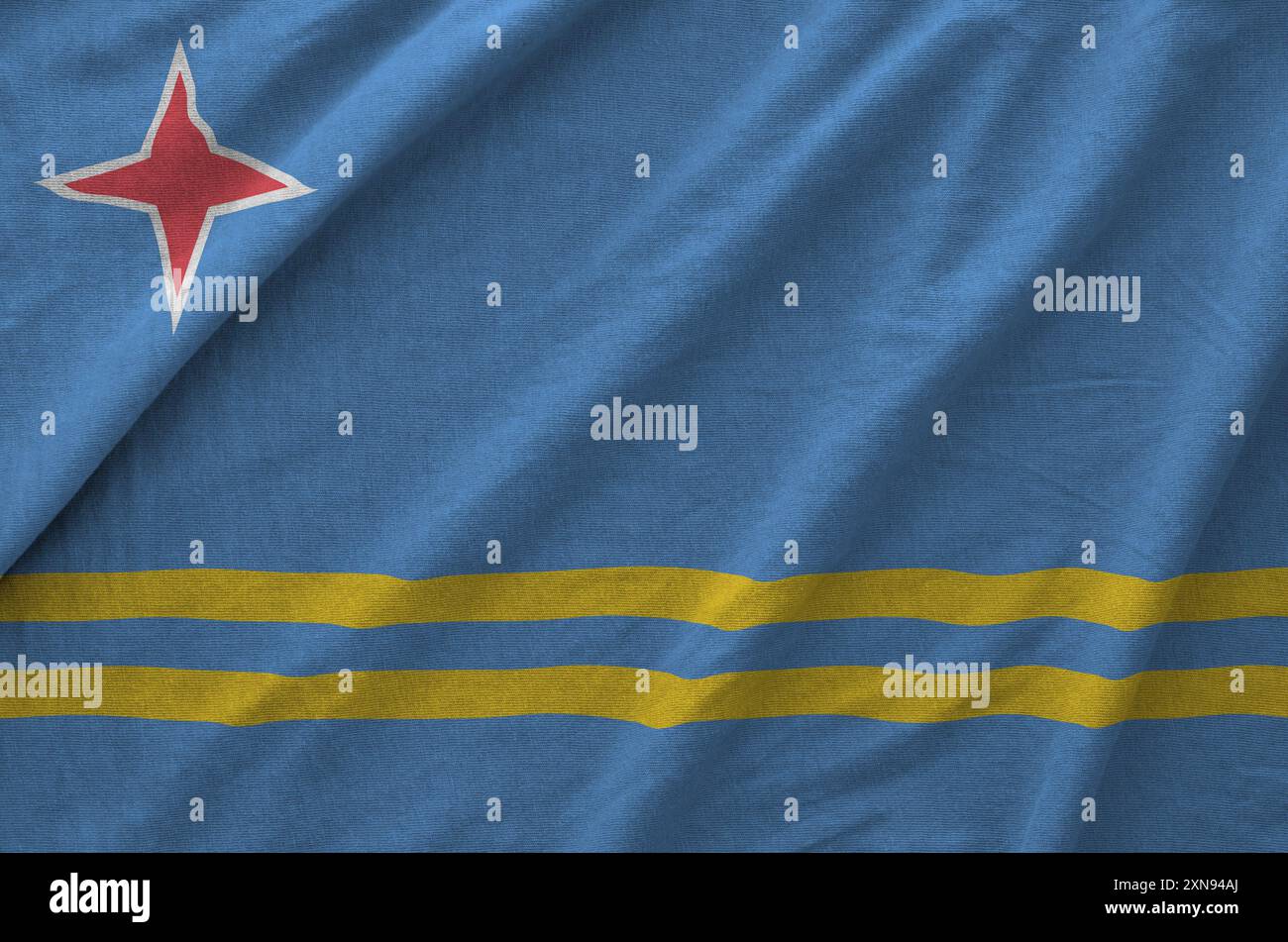 Aruba flag depicted on folded wavy fabric of old cloth close up Stock Photo