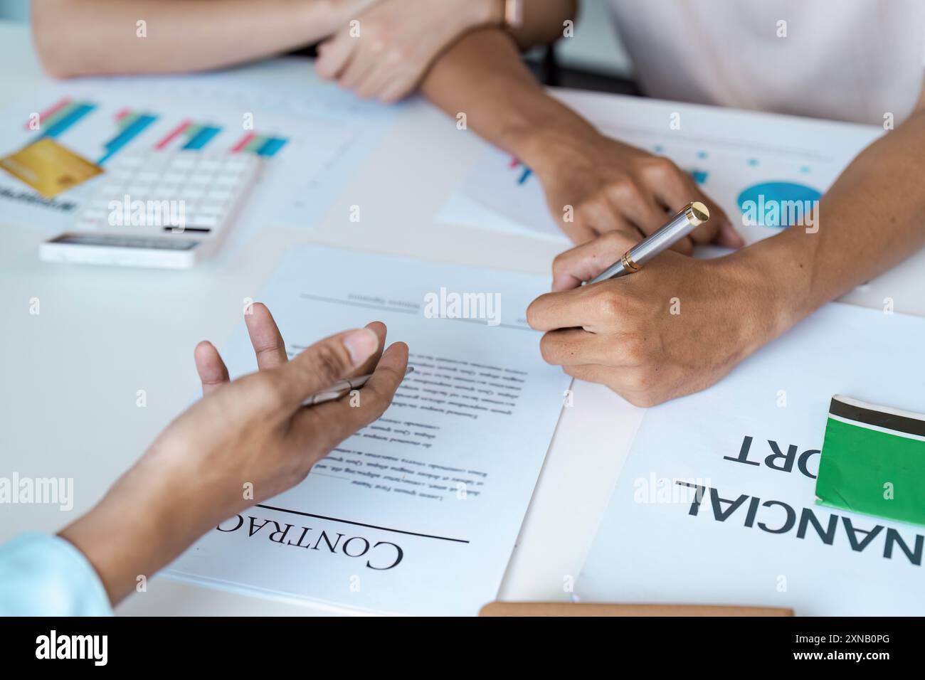 Business Meeting with Financial Reports and Contract Signing in Modern ...