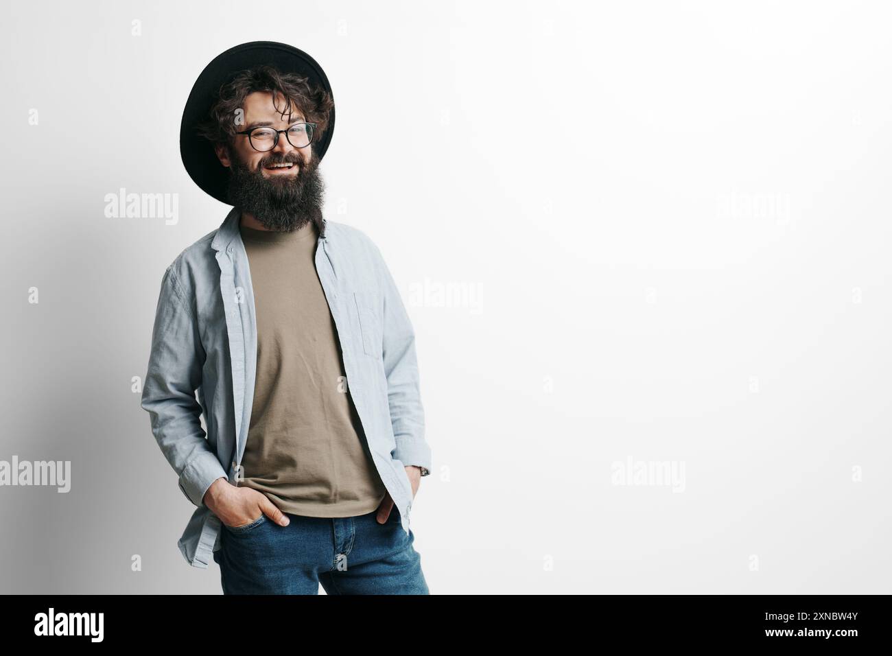 Stylish bearded man smiling in studio portrait Stock Photo