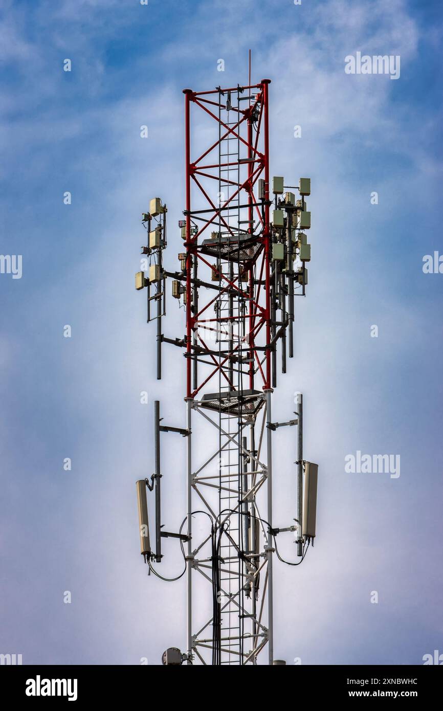 tower cellular antenna, against the blue sky in the morning Stock Photo