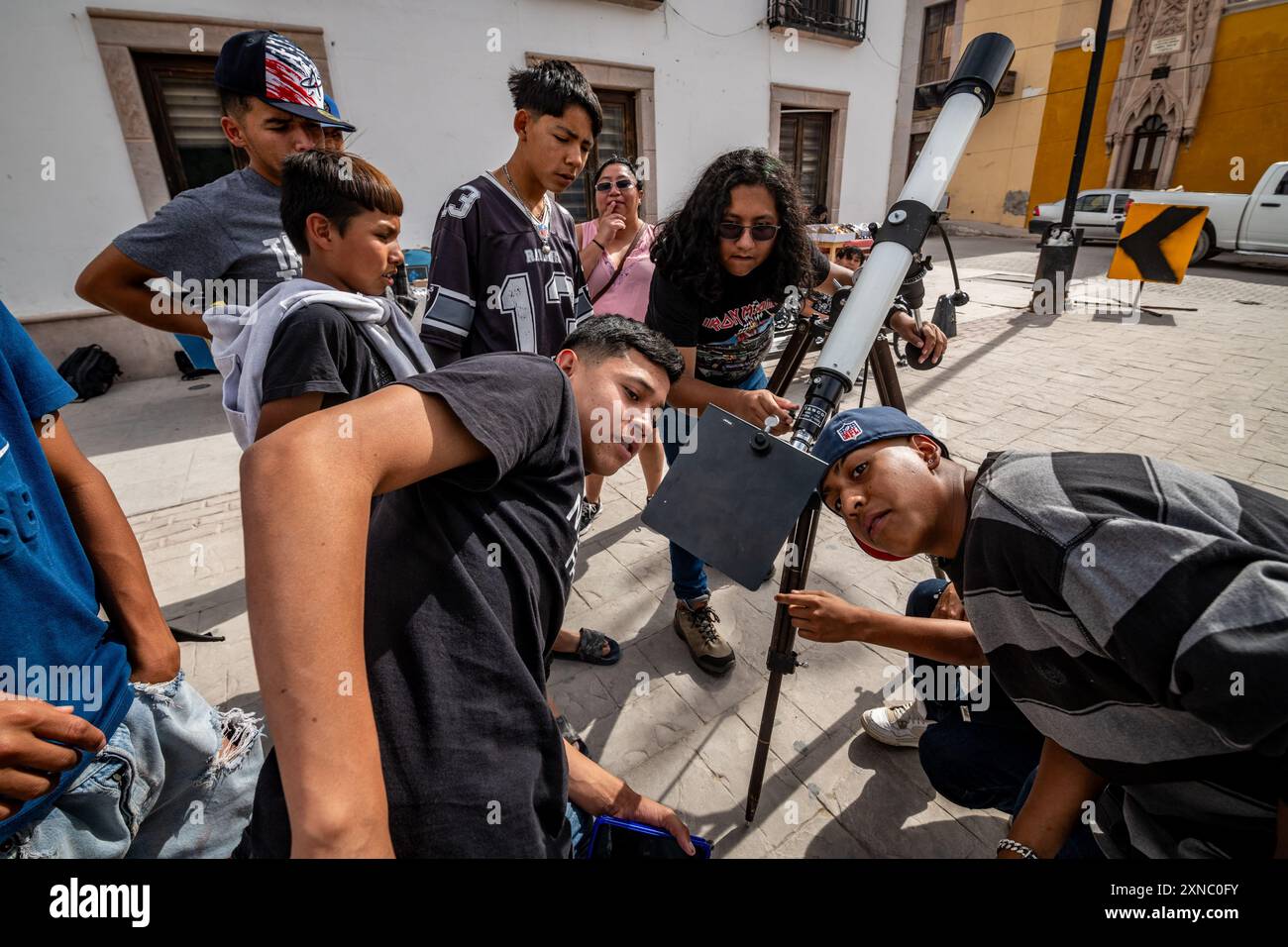 Community looking through telescope for the 2024 eclipse in Mapimi