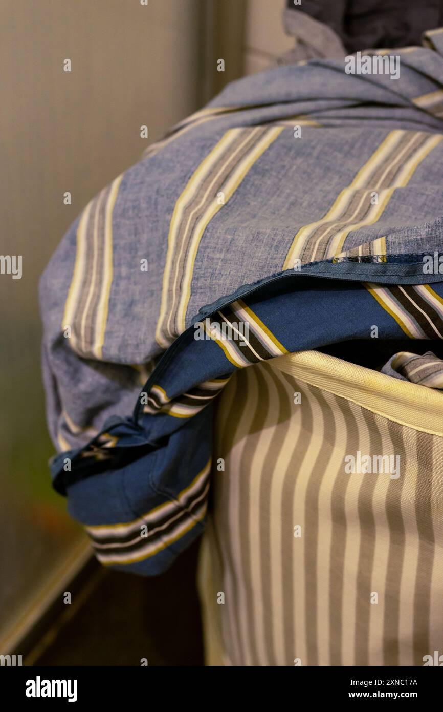 Basket with dirty bed linen before future washing Stock Photo