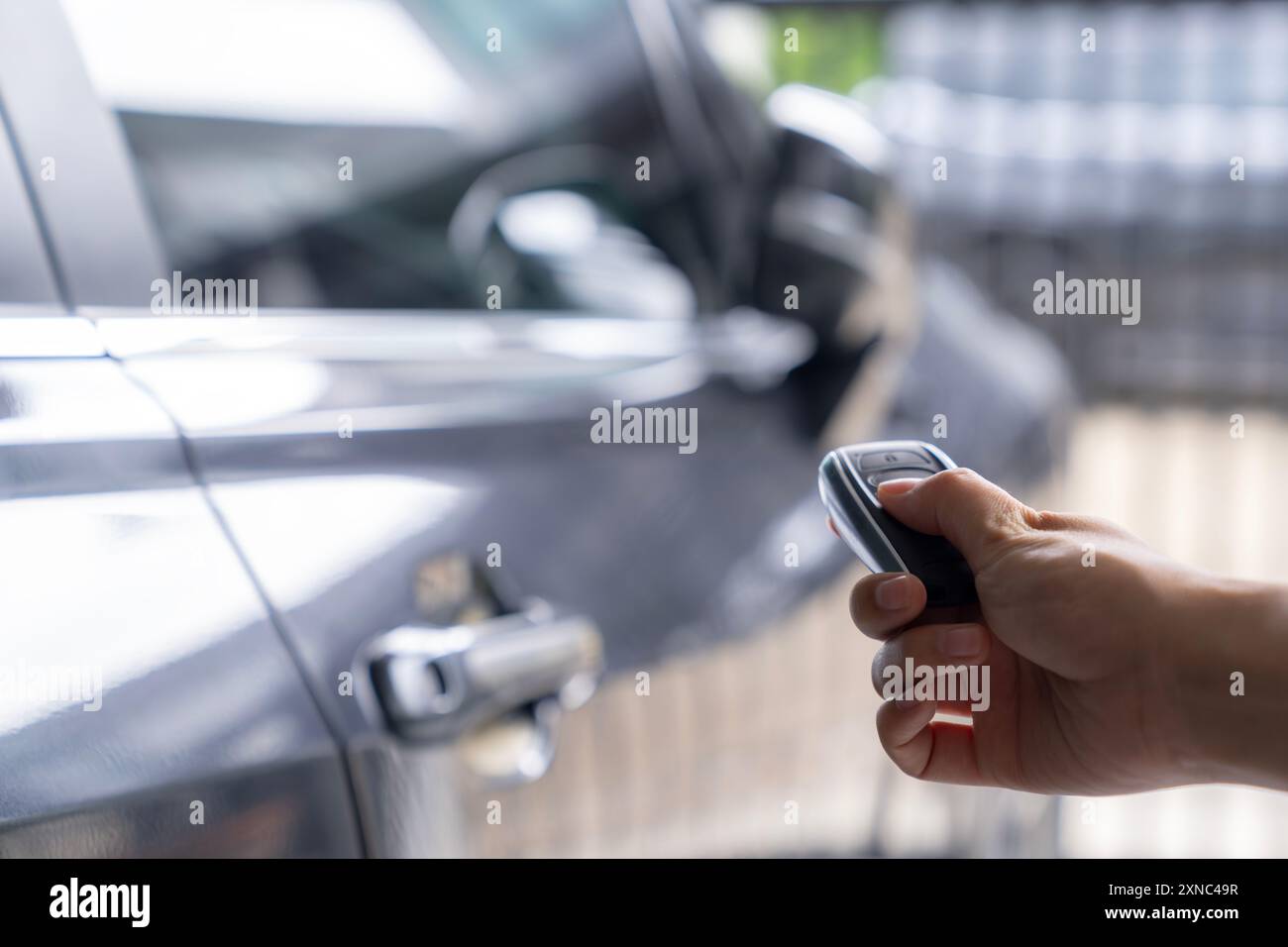 Hand unlocking car with car key Stock Photo