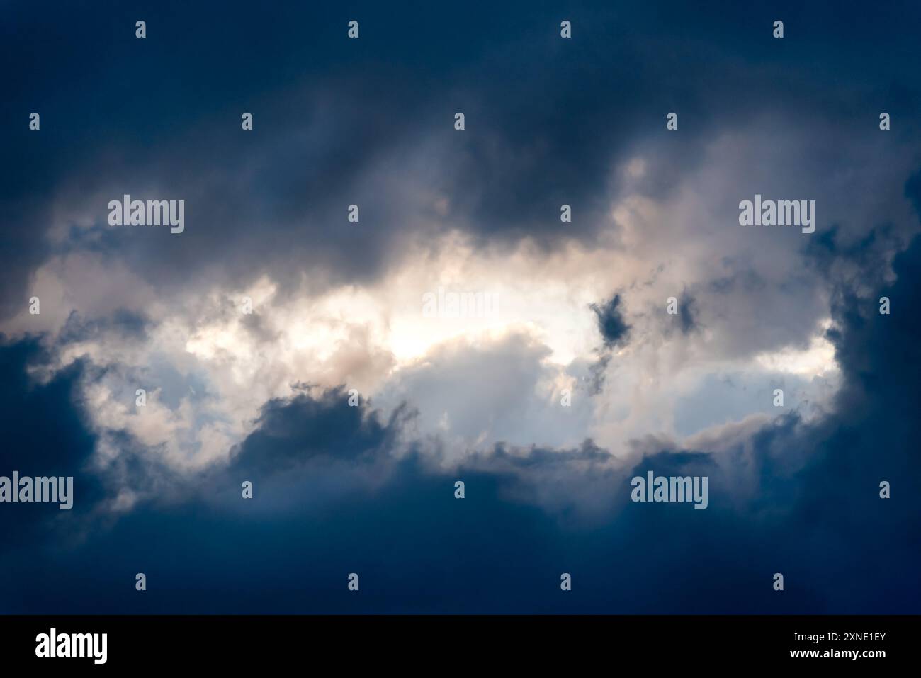 Dark and Dramatic Storm Clouds framing a clear sky Area Background ...