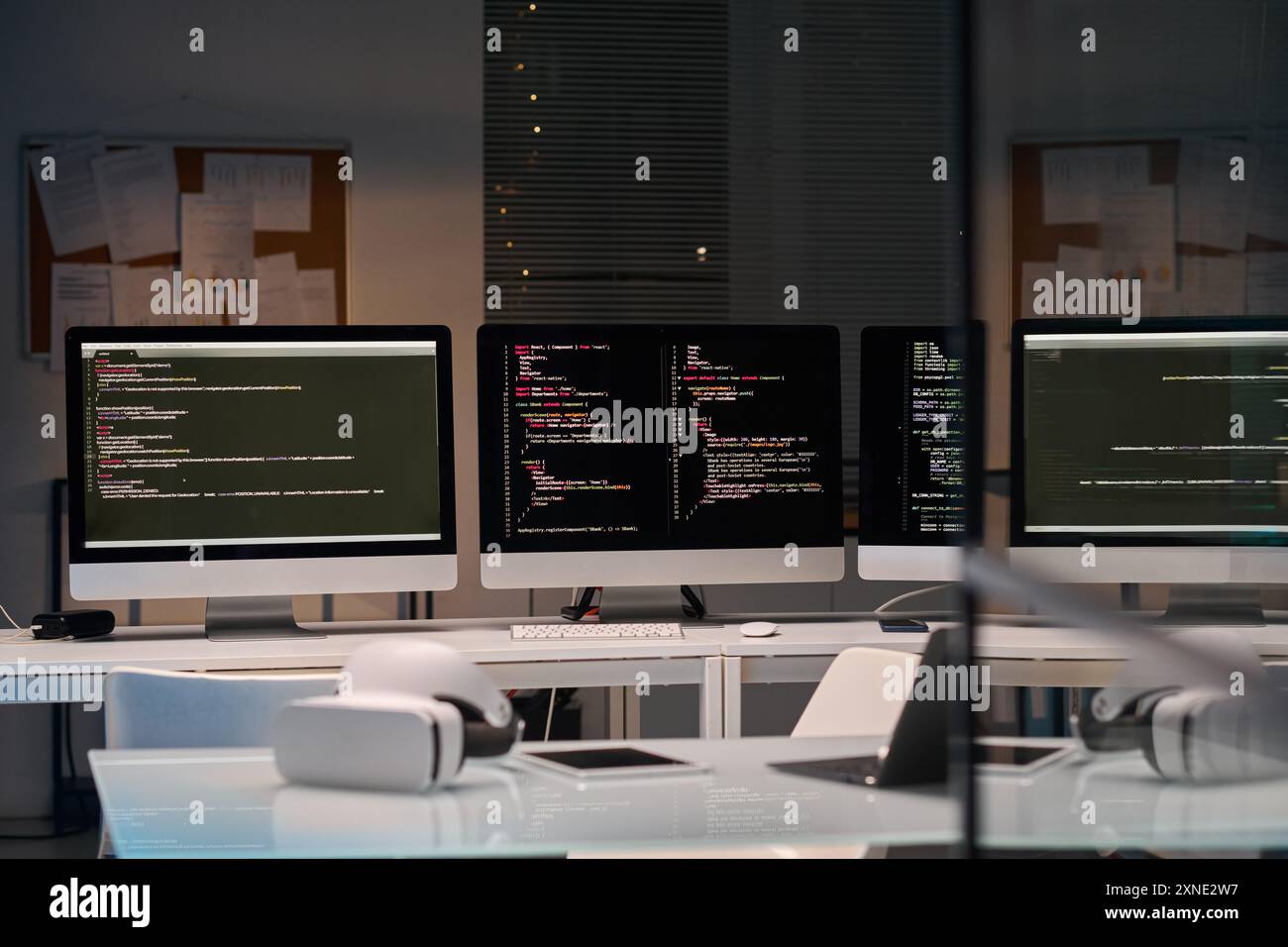 Background image of three computer screens with code lines cybersecurity office, copy space Stock Photo