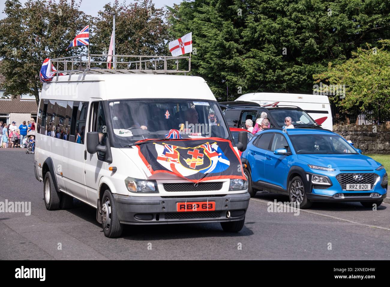 Ballyclare, Northern Ireland - August 27th, 2022: white van RBP 63 with Royal Black Institution flag, union jack flags and Ulster flags. Stock Photo