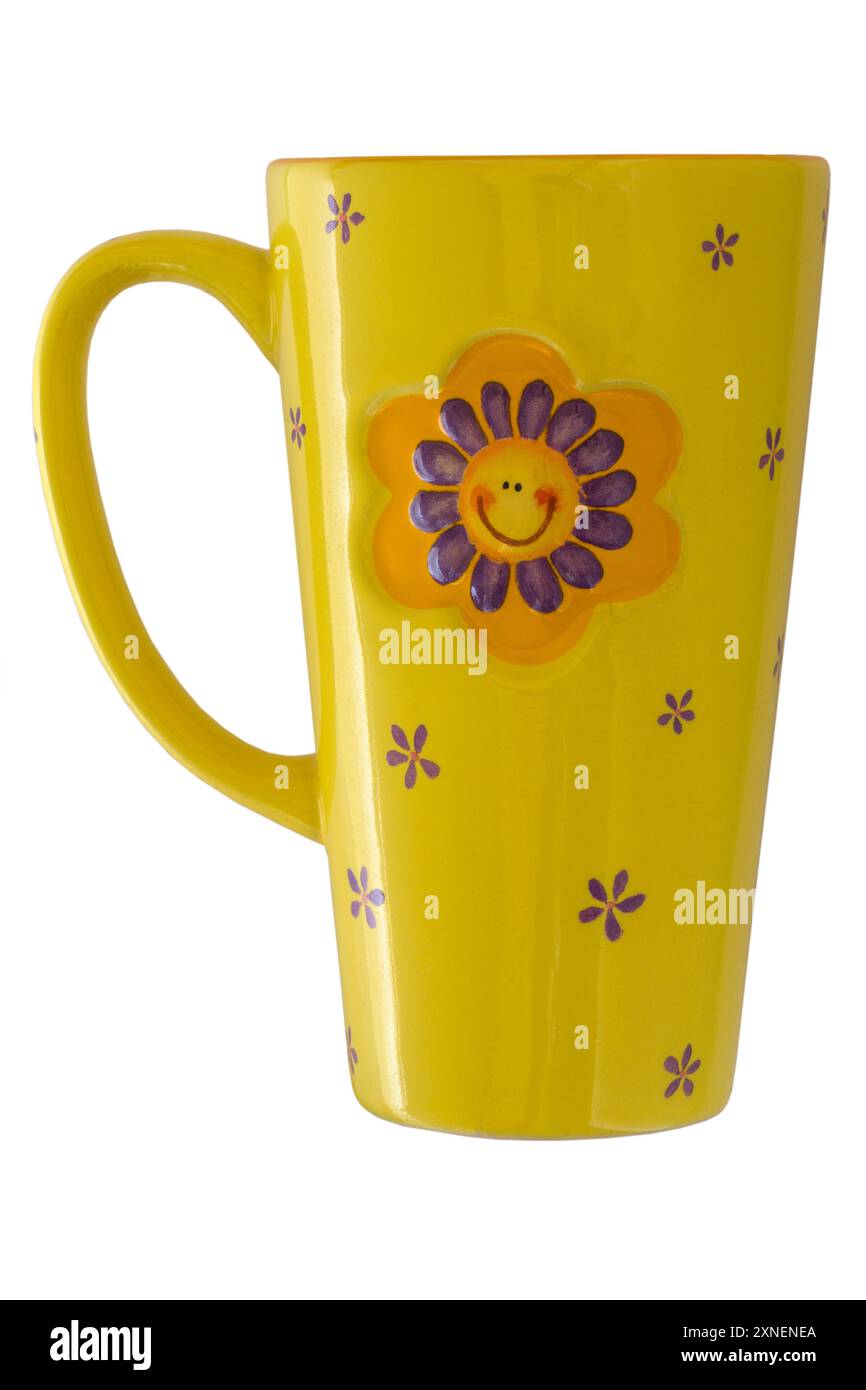 Yellow mug with smiley flower face on isolated on white background Stock Photo