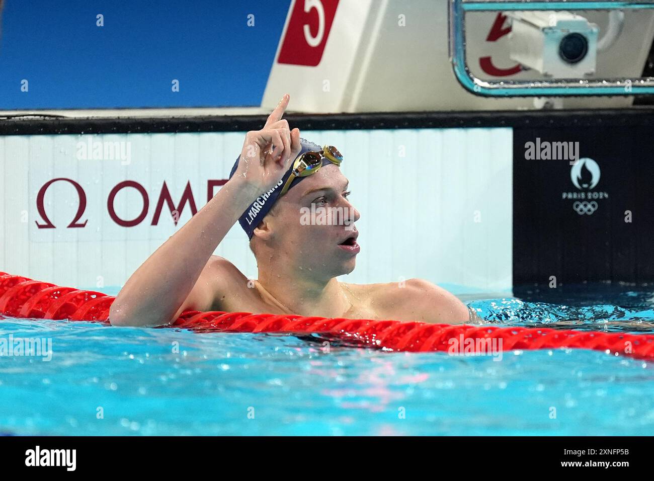 France's Leon Marchand celebrates after winning the men's 200m