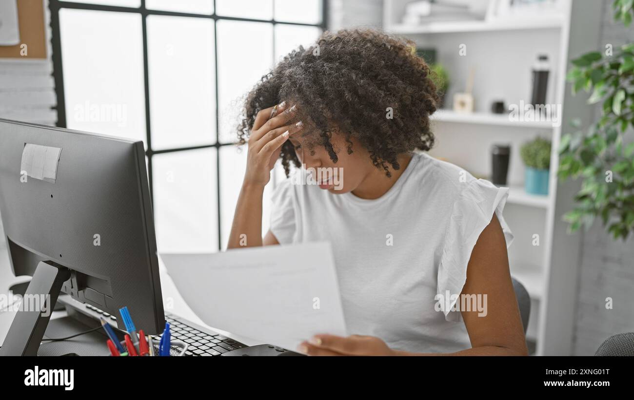 Stressed african american woman with documents in an office Stock Photo ...