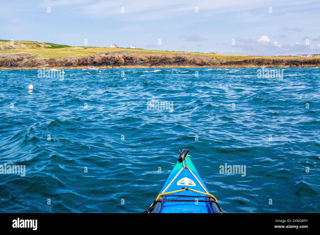 A sea kayak in the tide races of Rhoscolyn Beacon off Anglesey, North ...