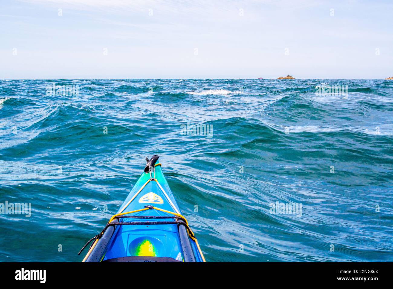 A sea kayak in the tide races of Rhoscolyn Beacon off Anglesey, North ...