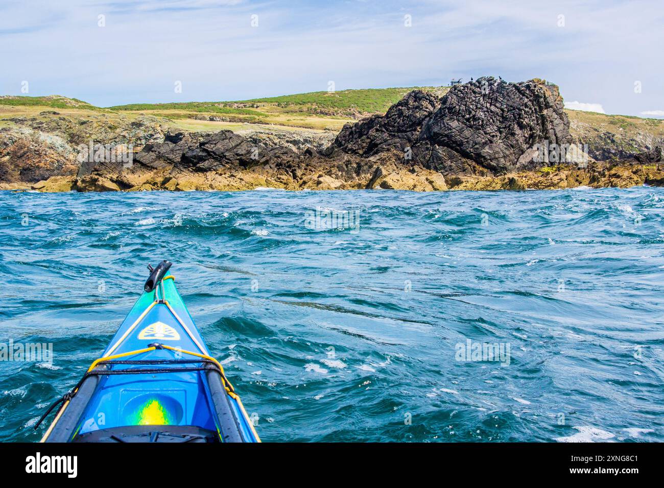 A sea kayak in the tide races of Rhoscolyn Beacon off Anglesey, North ...