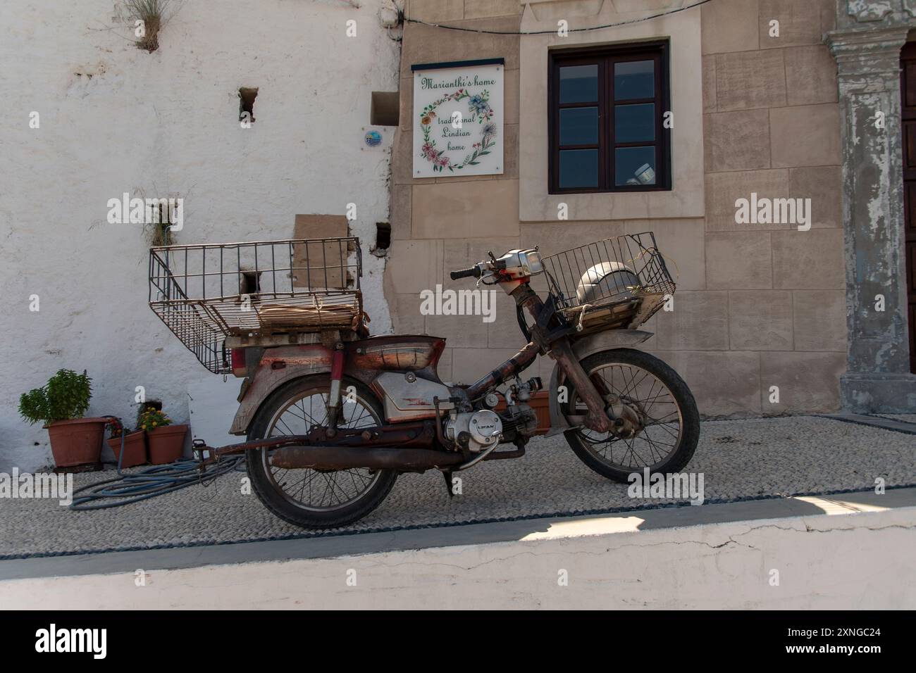Old, rusty Scooter, parked up in Lindos on the Greek island of Rhodes ...