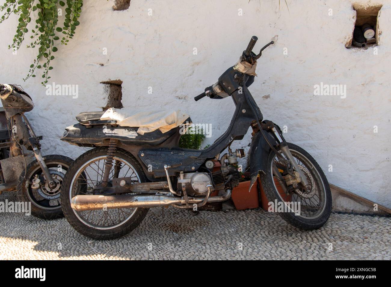 Old, rusty Scooter, parked up in Lindos on the Greek island of Rhodes ...