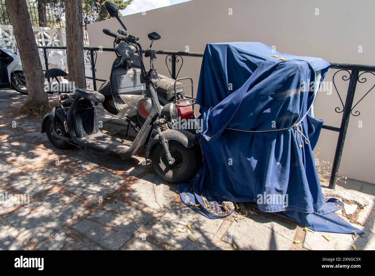 Old, rusty Scooter, parked up in Lindos on the Greek island of Rhodes ...