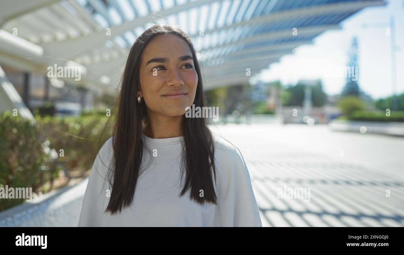 Young woman enjoying a sunny day in an urban park with modern ...