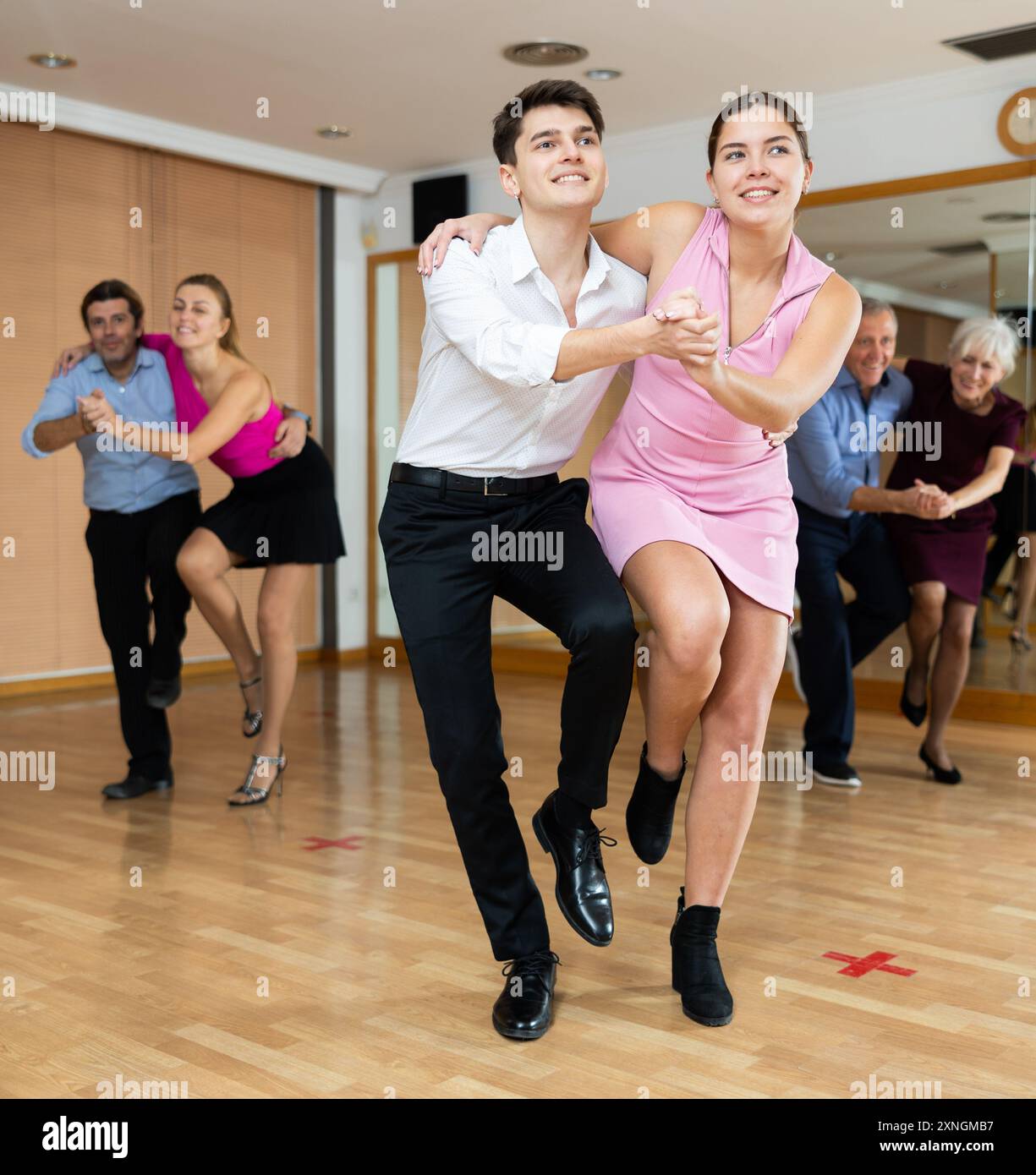 Young pair practicing Latino dance in dance studio Stock Photo
