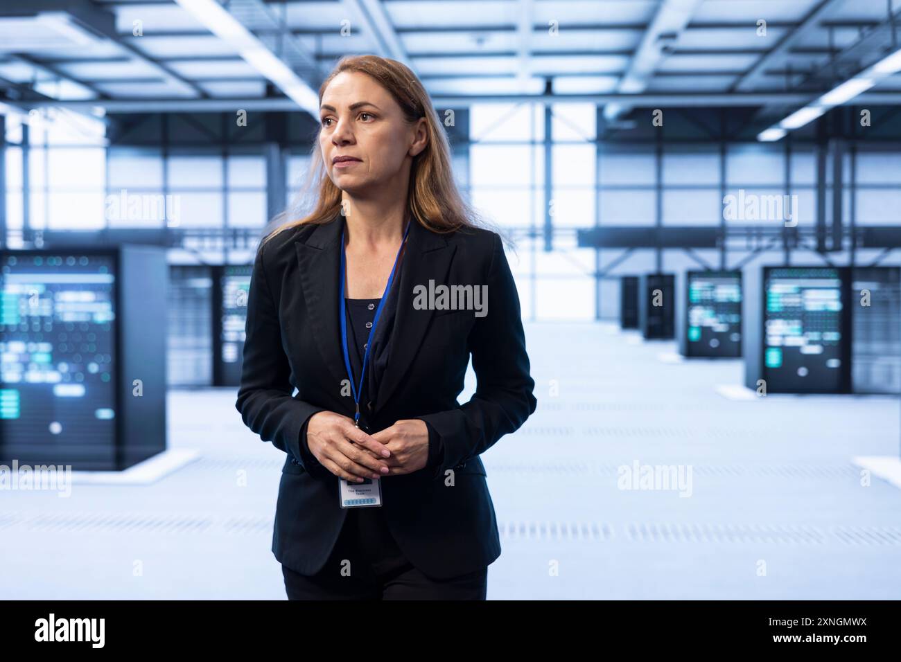 System administrator in data center identifying and solving technical issues related to data center infrastructure. IT expert managing, maintaining and securing high tech server hub environment Stock Photo