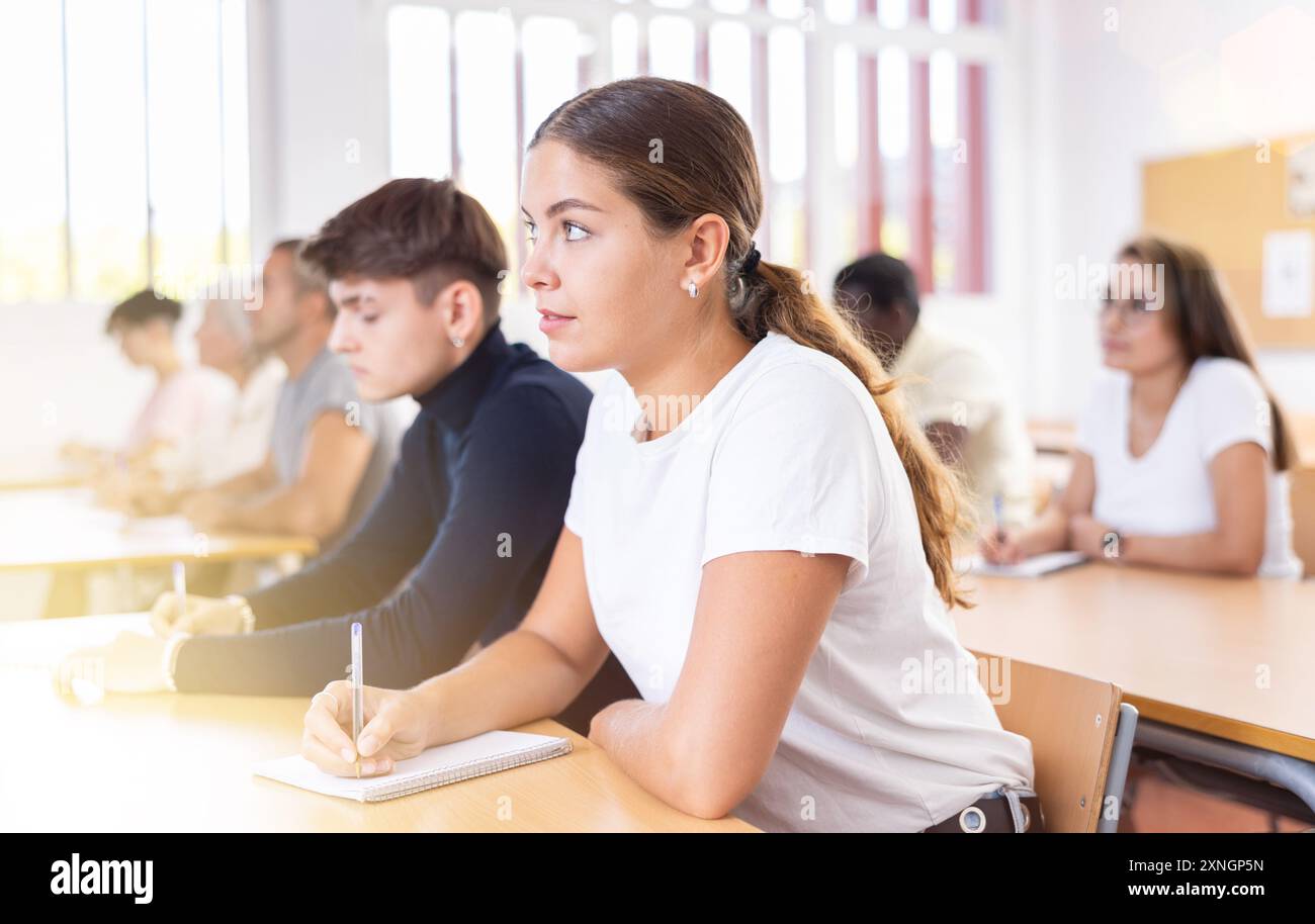 Girl attending lecture in college Stock Photo - Alamy