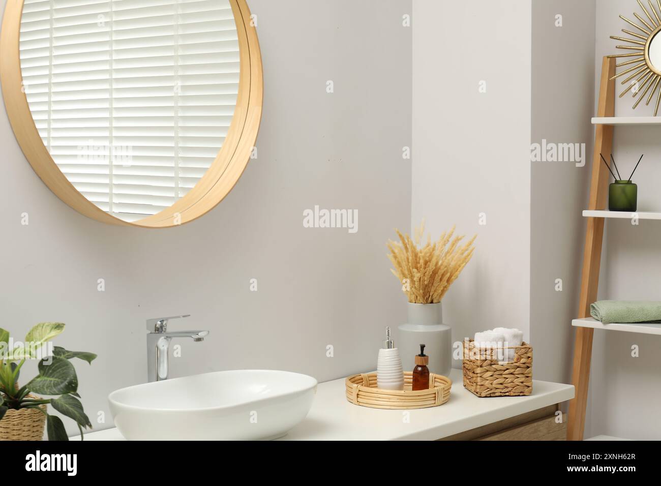Round mirror over sink in bathroom. Interior design Stock Photo - Alamy