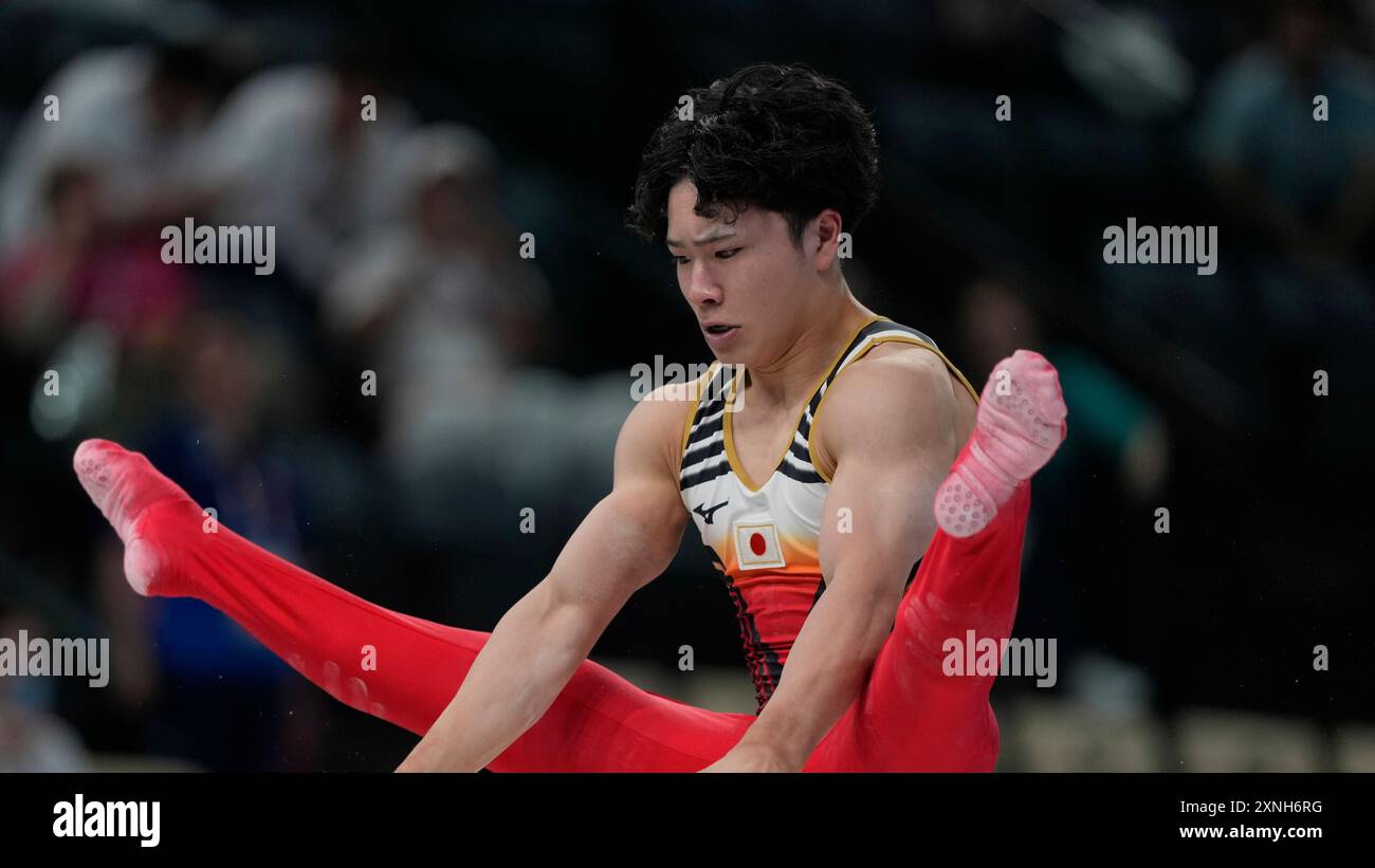 Shinnosuke Oka, of Japan, performs on the parallel bars during the men
