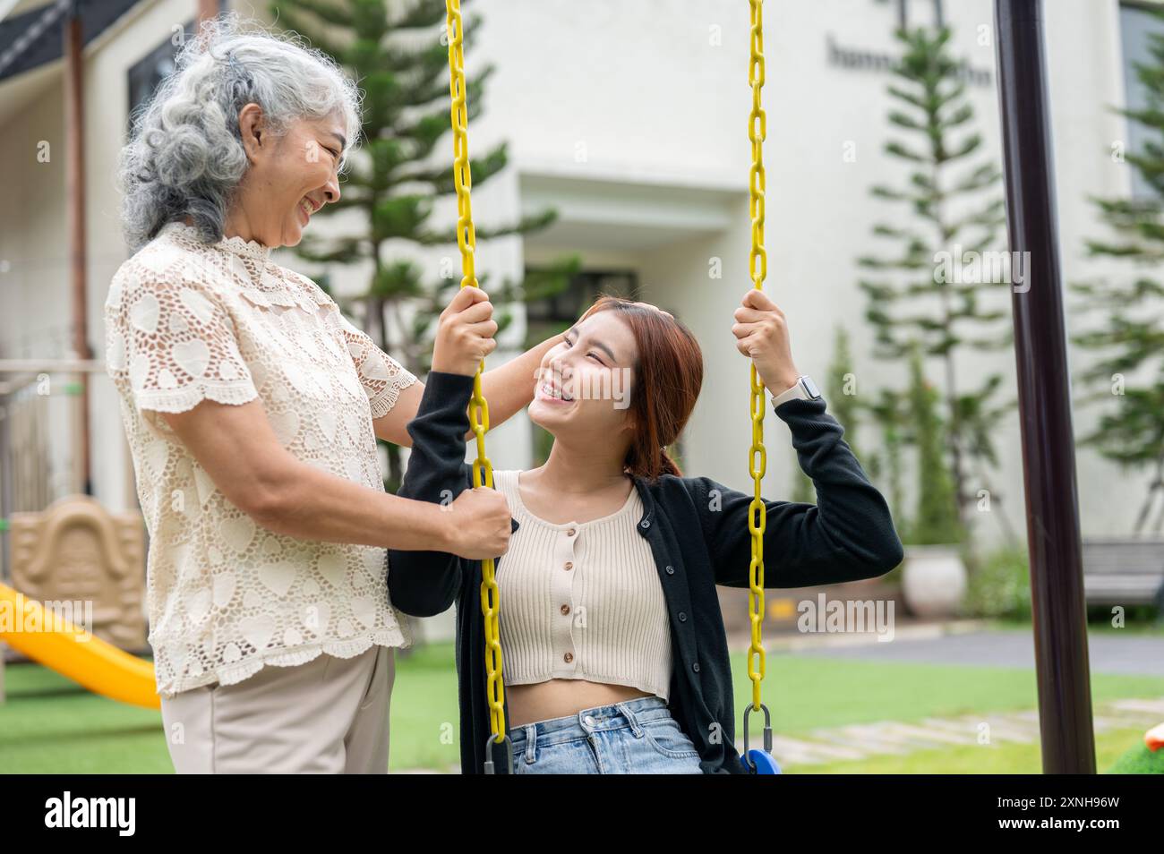 A happy, positive retired Asian grandma is talking and gently touching