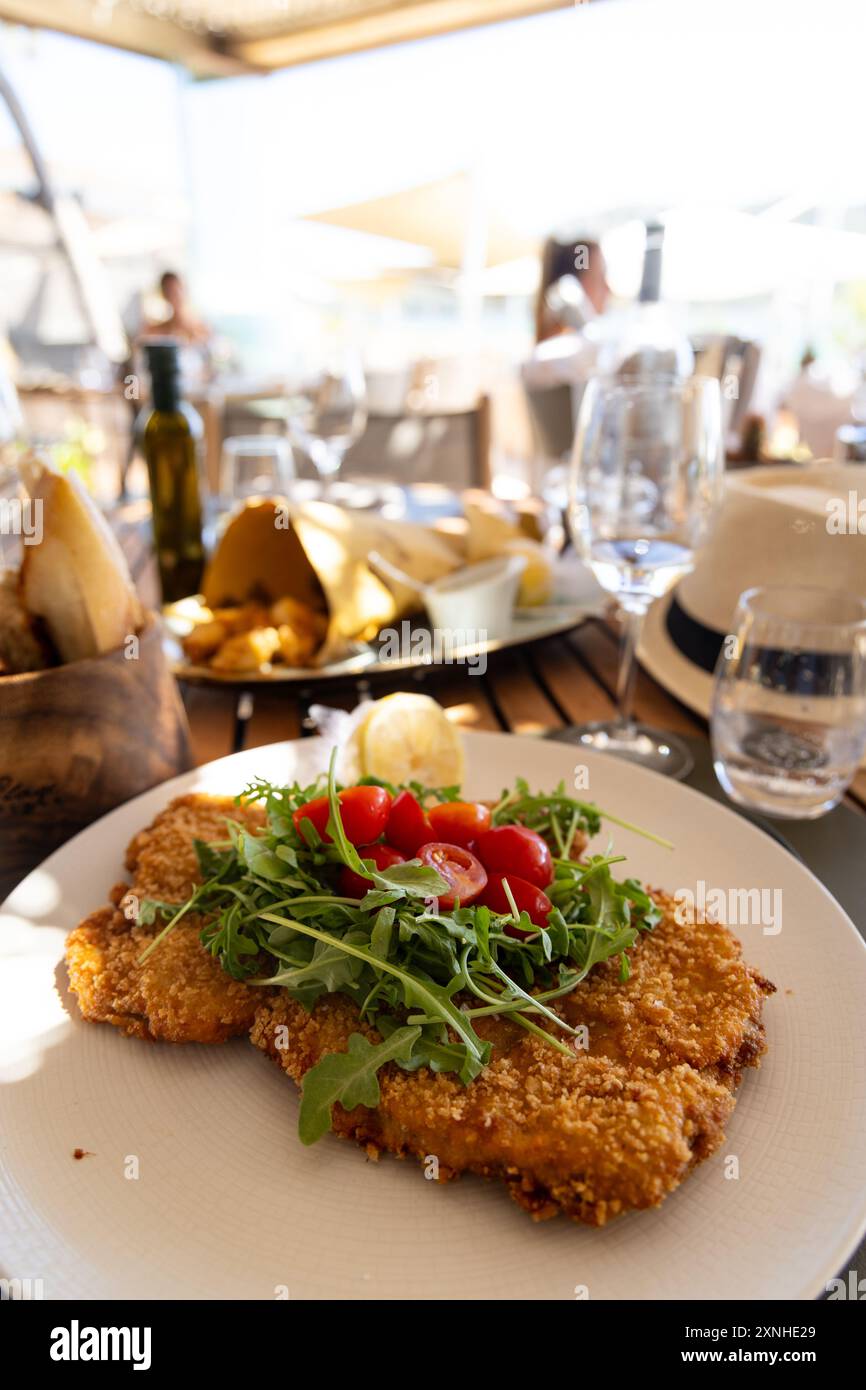 breaded pork cutlet served with salad Stock Photo