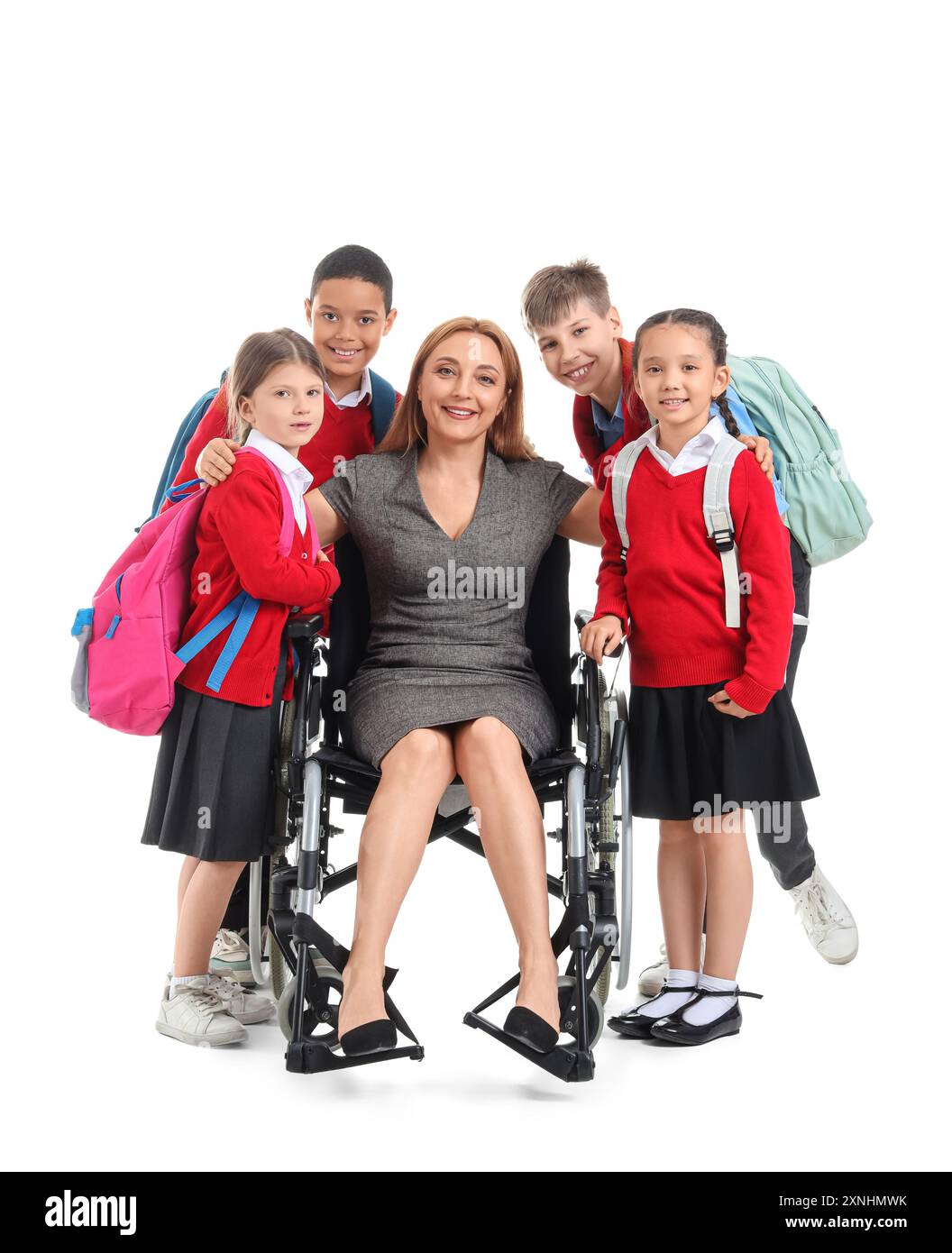 Mature teacher in wheelchair with little pupils hugging on white ...