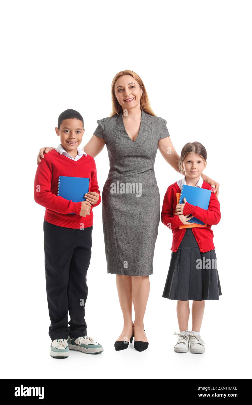 Mature teacher hugging little pupils on white background Stock Photo ...