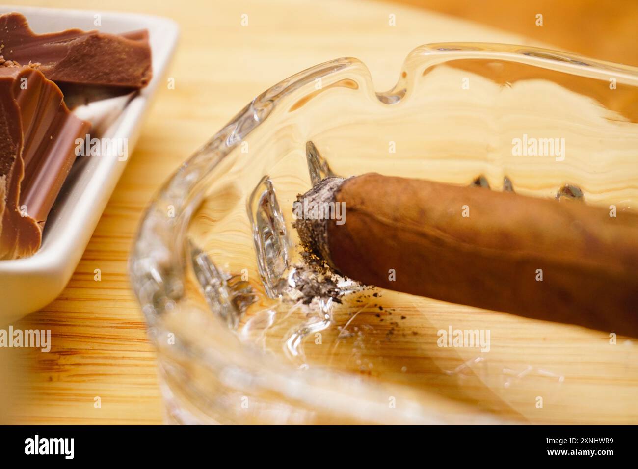 Cigar whiskey chocolate and nuts on wooden table close up view Stock Photo