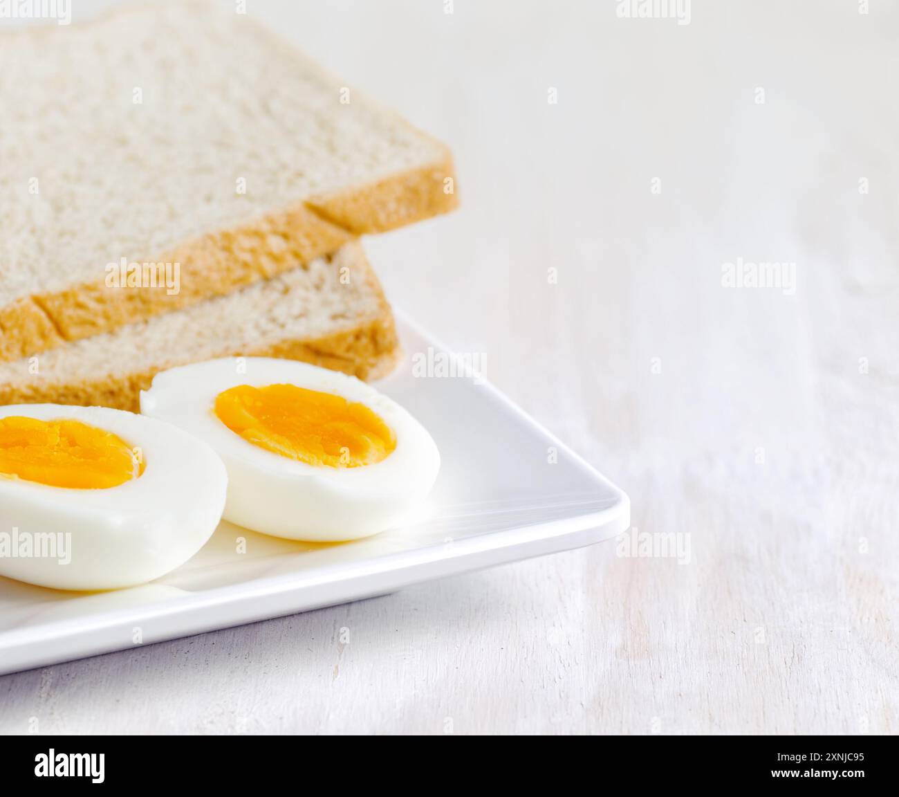 Boiled egg and toasts on white plate Stock Photo