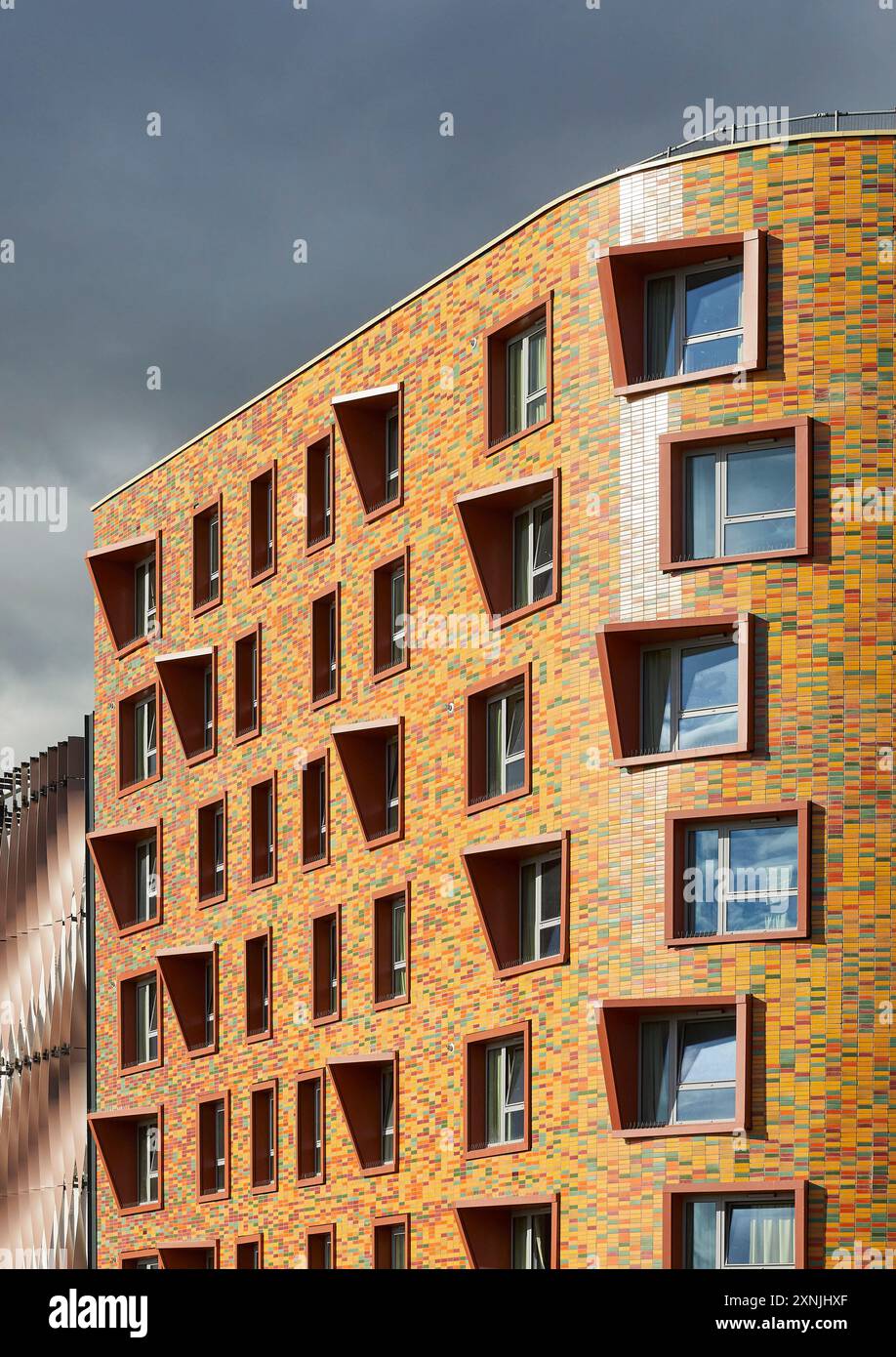 Multi-coloured tiles of exterior facade. Swansea Arena  and Copr Bay Bridge, Swansea, United Kingdom. Architect: acme, 2024. Stock Photo