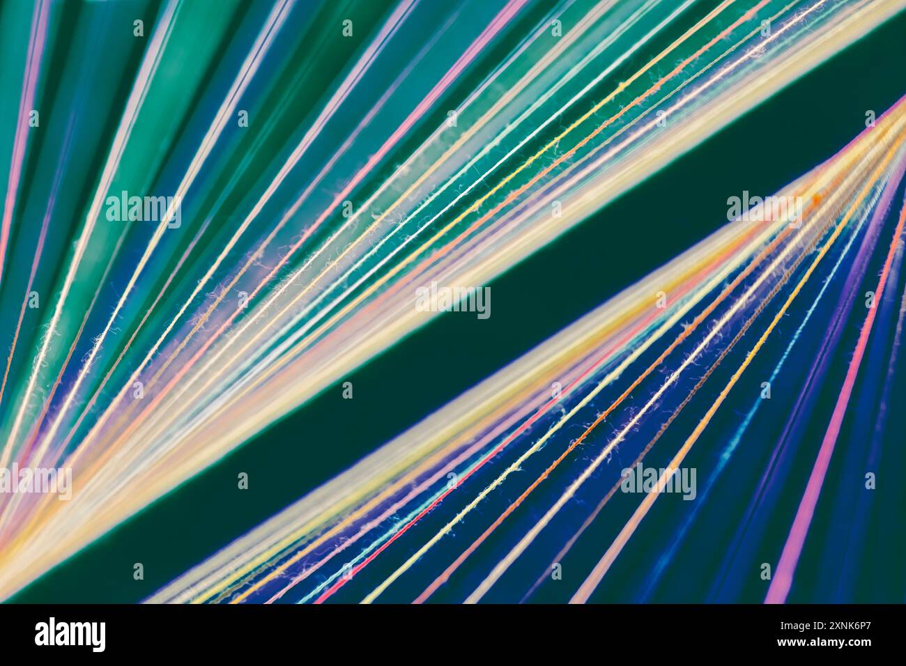 Converging Multi-colored Sewing Thread on a green background Stock ...
