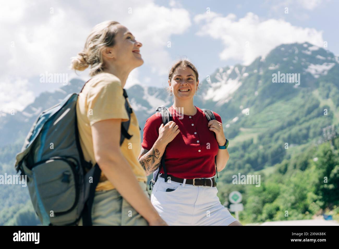 Portrait of two confident women with backpacks going hiking in the ...