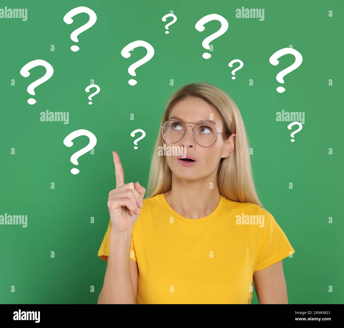 Woman making something up on green background. Question marks around ...
