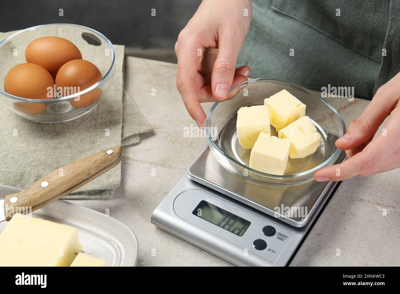 Woman weighing butter on digital hi-res stock photography and images ...