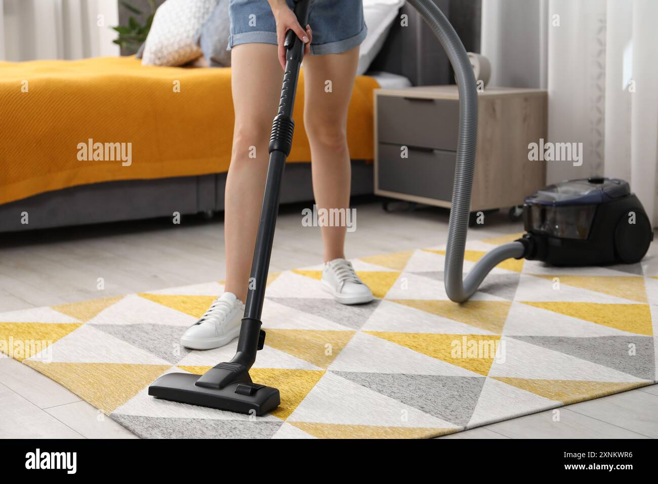 Woman vacuuming carpet at home, closeup view Stock Photo - Alamy