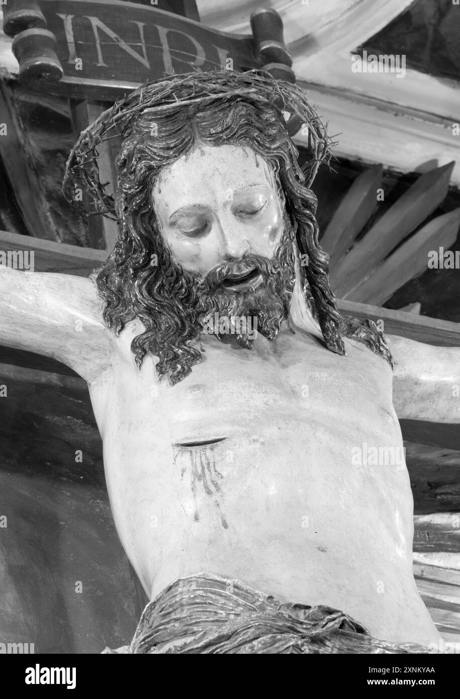 ASSISI, ITALY - MAY 17, 2024: The carved polychrome statue of Crucified Jesus in the church Cathedral San Rufino from year 1561. Stock Photo