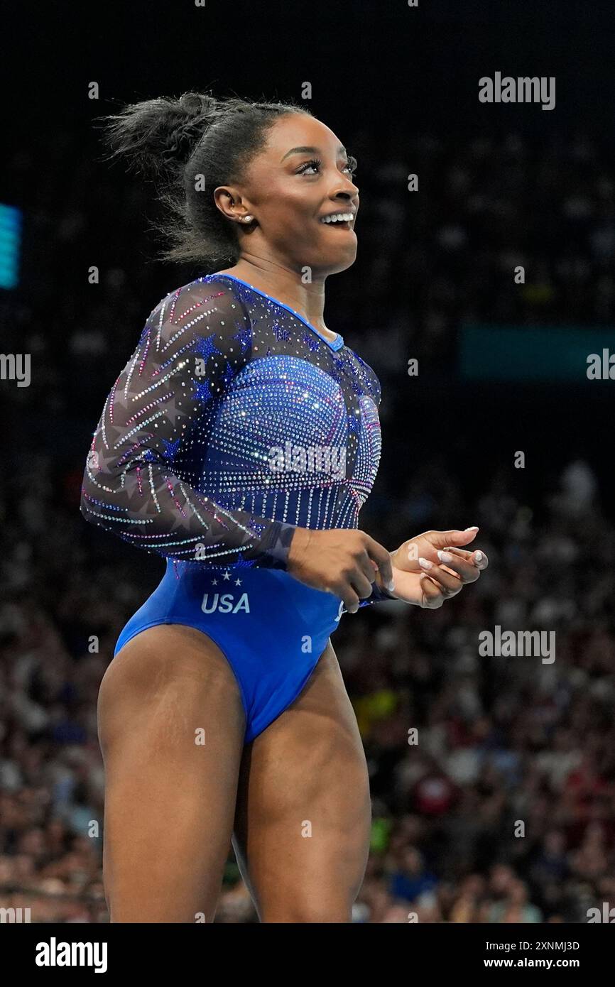 Simone Biles, of the United States, smiles after performing on the ...