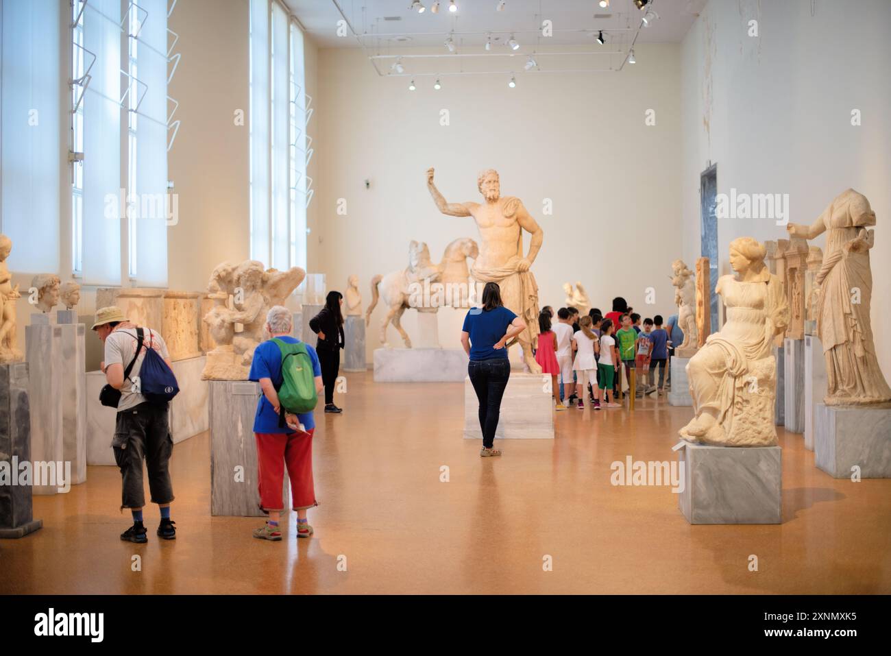 National Archaeological Museum Ancient Greek Sculptures Athens Greece // ATHENS, Greece — The National Archaeological Museum in Athens hosts an extensive array of sculptures and statues, representing some of the finest examples of ancient Greek art. The museum's collection spans several historical periods, including the Archaic, Classical, and Hellenistic eras, showcasing the evolution of Greek sculpture through centuries. Visitors can admire iconic works such as the Aphrodite of Arles and the Kouros statues, which reflect the artistic excellence and cultural heritage of ancient Greece. Stock Photo