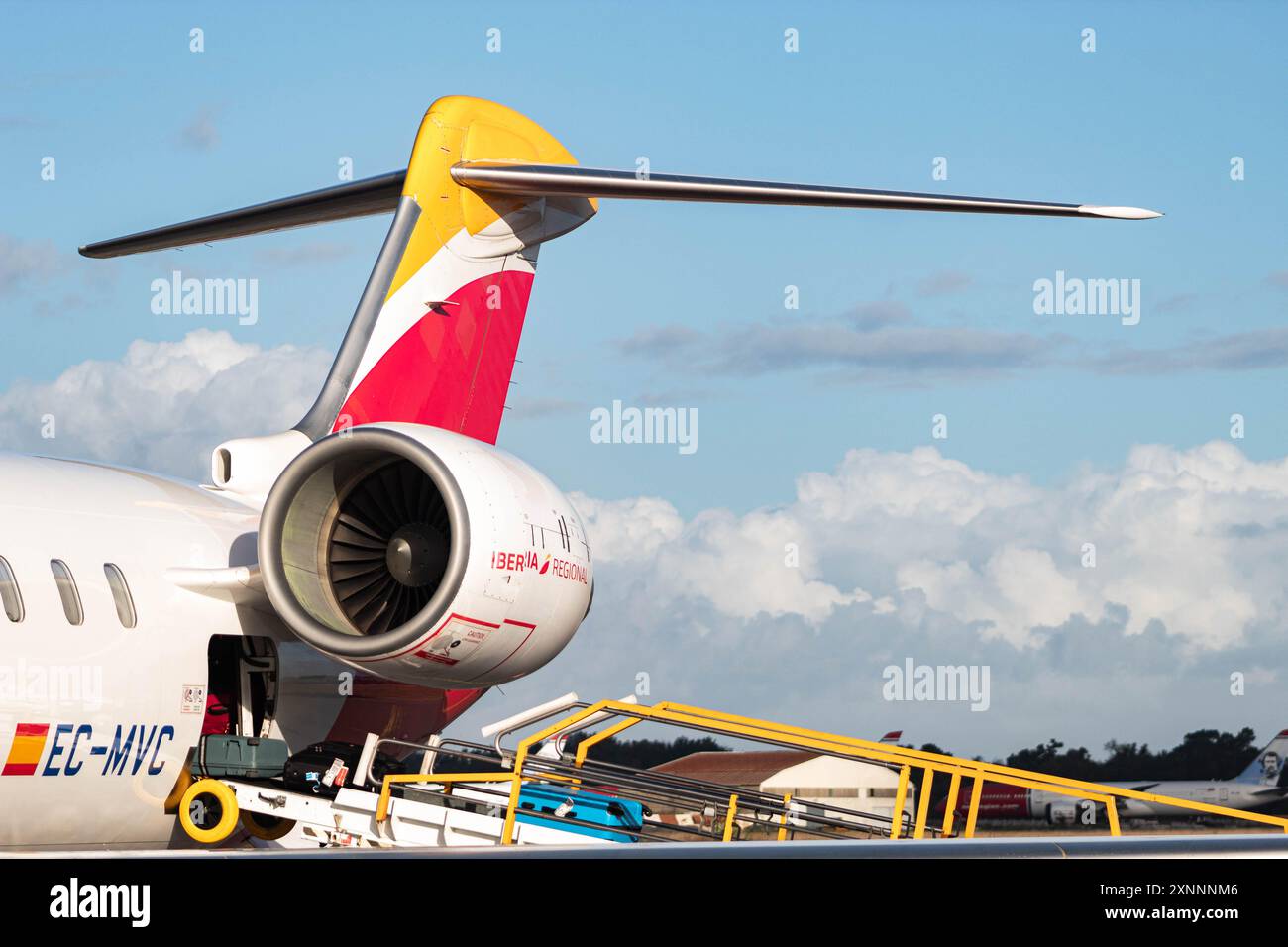 Iberia's CRJX loading, with cloudy sky as background Stock Photo