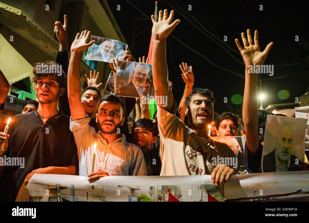 Kashmiri Shia Muslims hold candles and placards while shouting pro ...