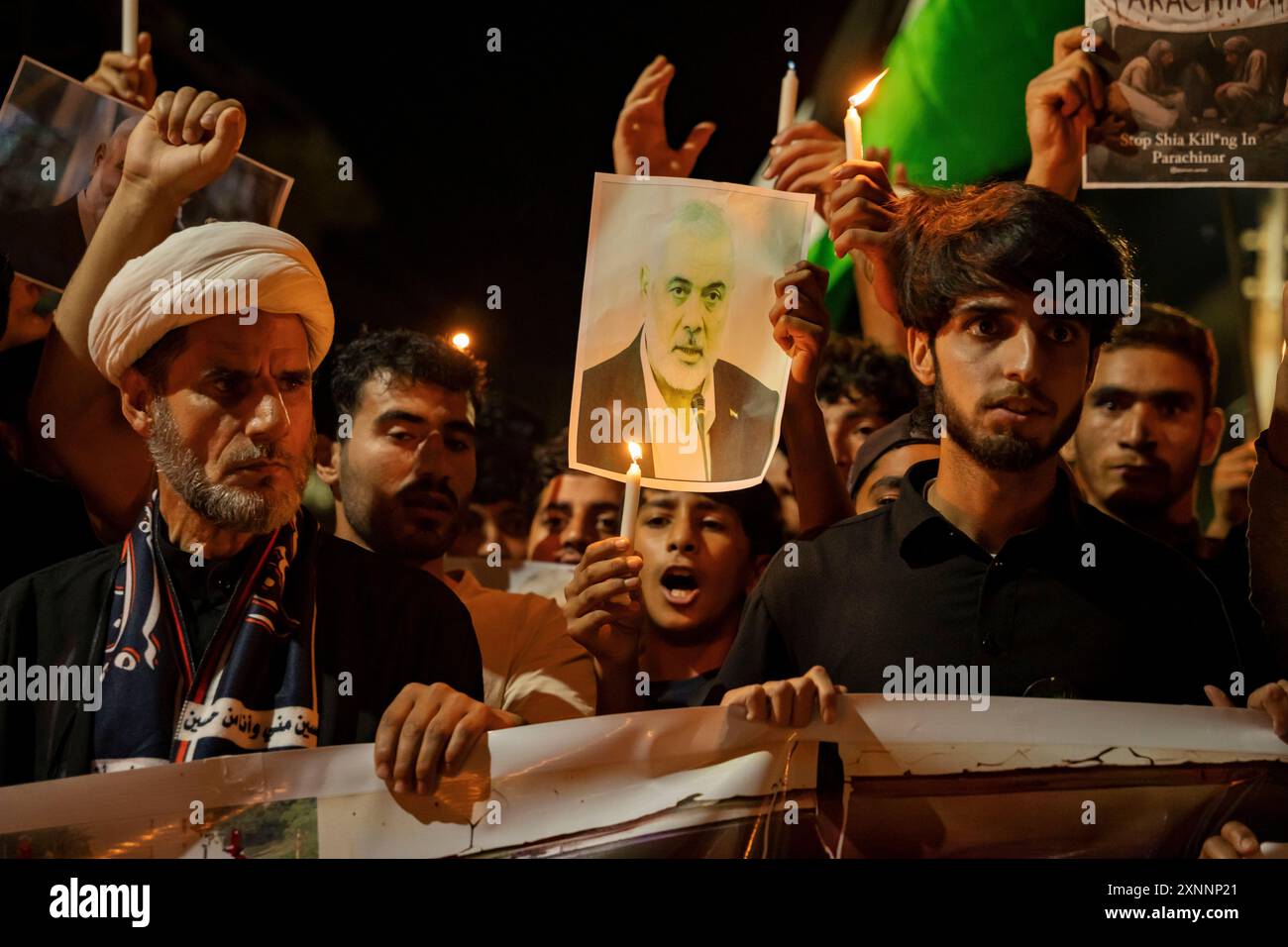 Kashmiri Shia Muslims hold candles and placards while shouting pro ...