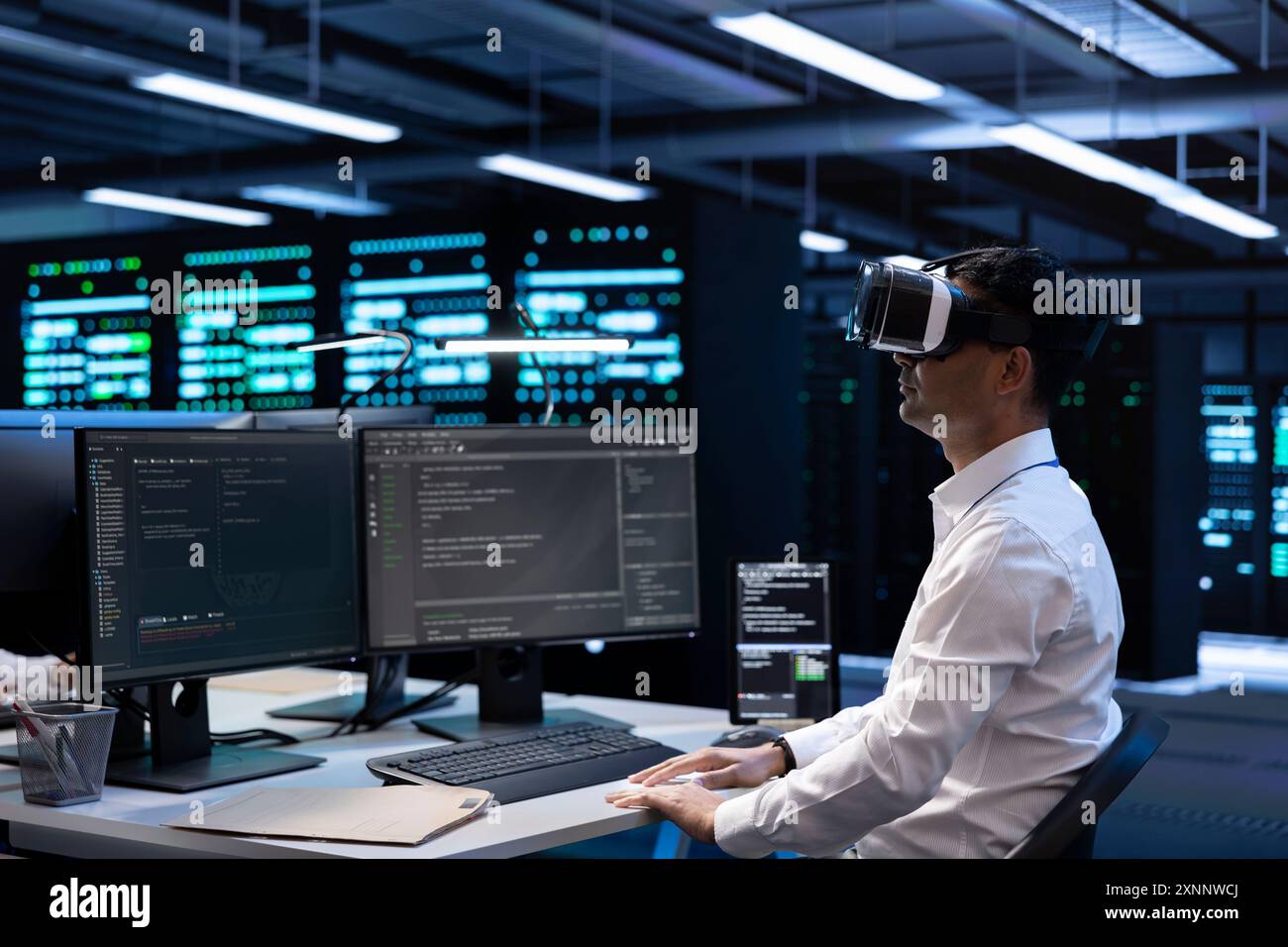 IT specialist using VR headset to do maintenance on server rows in computer network security data center. Engineer using virtual reality to do checkup on mainframes providing processing resources Stock Photo