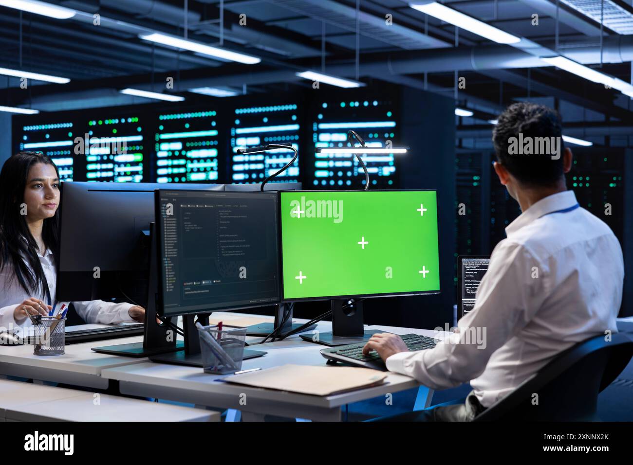 Admin coworkers using mockup computer monitor to check server clusters ...