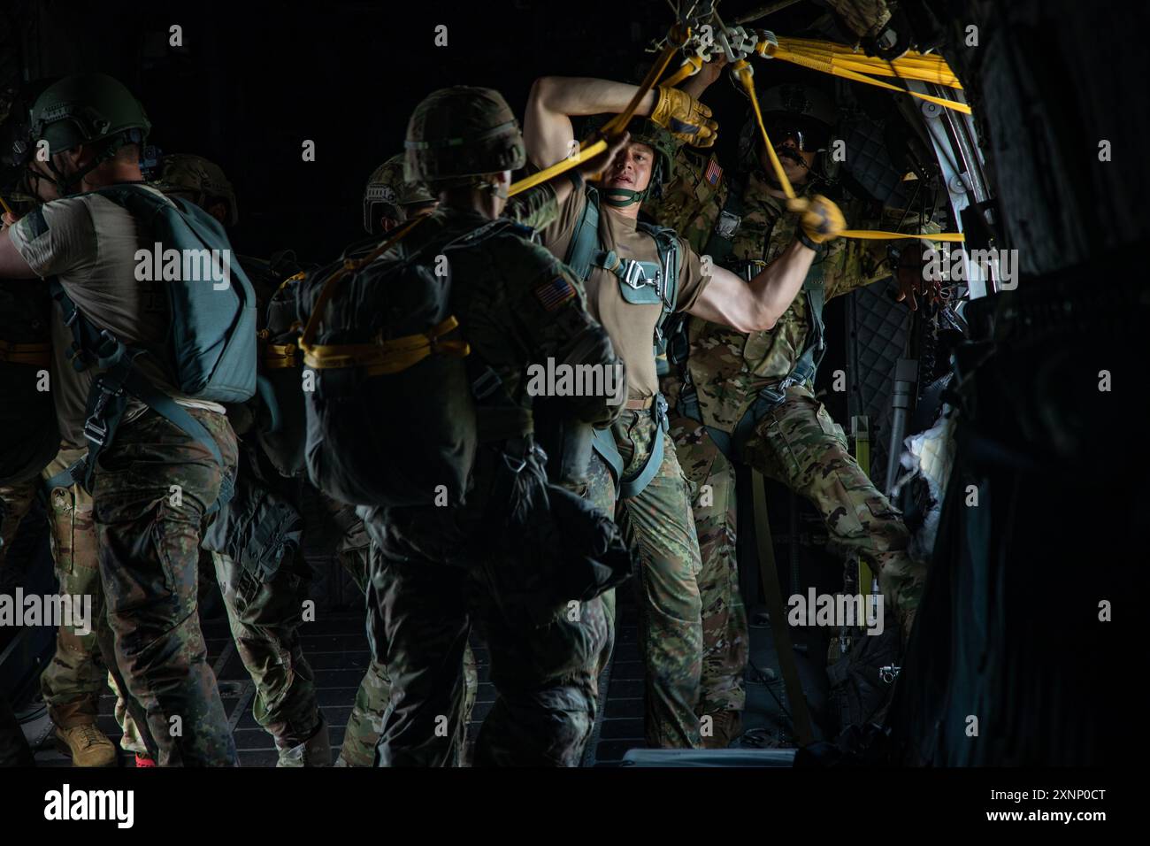 240718-A-HZ000-1277 German jumpmasters attached to 3rd Special Forces Group (Airborne) conduct jumpmaster duties aboard a C-27 high performance aircraft over Luzon DZ, North Carolina, July 18, 2024. This airborne operation was conducted with German jumpmasters to promote cohesion and interoperability with partner nations. (U.S. Army photo by Sgt. Benjamin D. Castro) Stock Photo