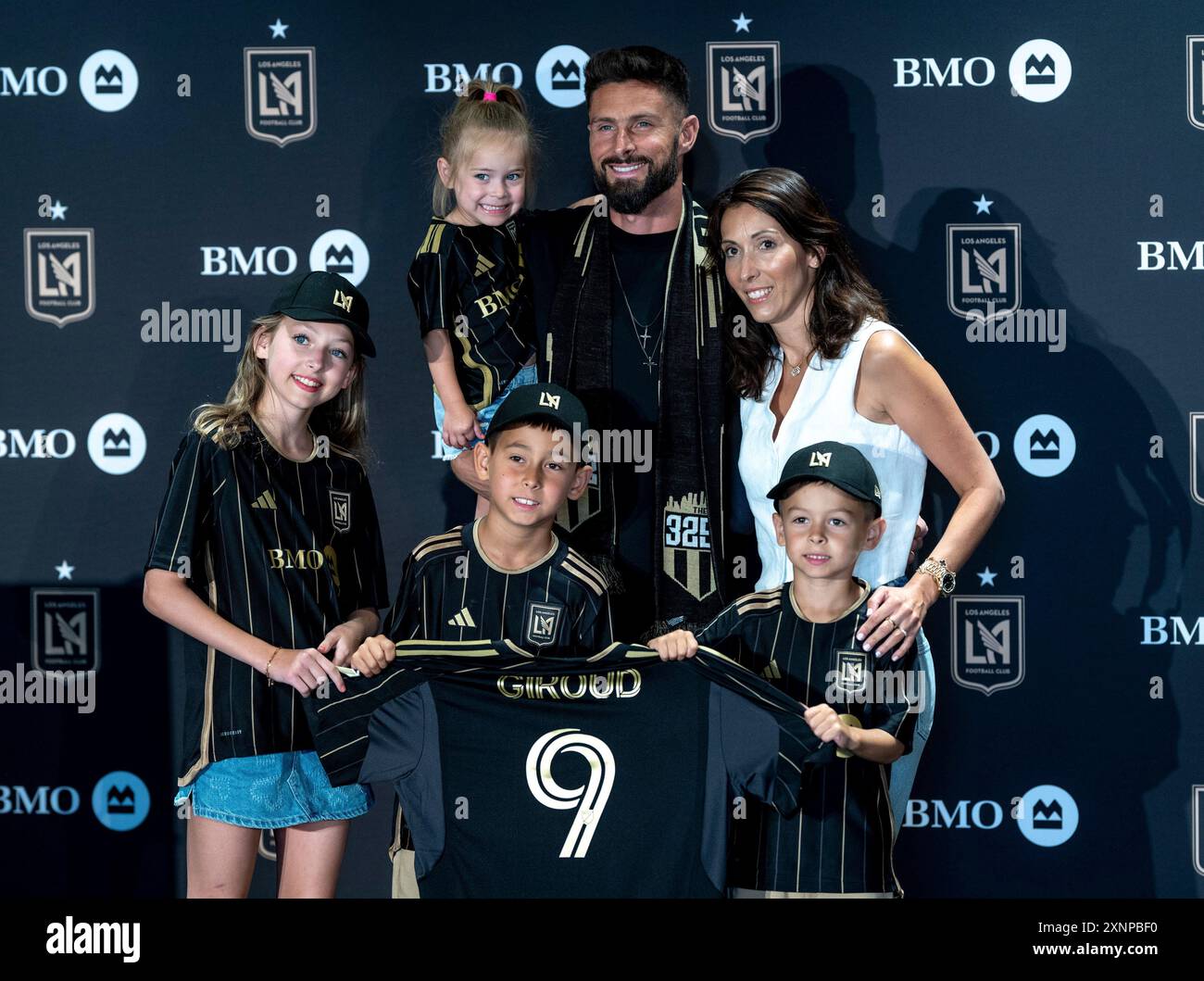 French forward Olivier Giroud poses with his wife Jennifer and their ...
