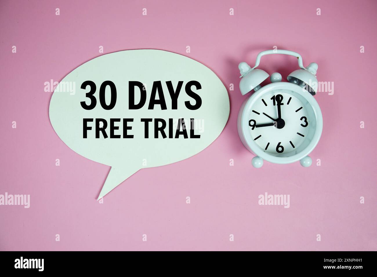 30 Days Free trial text on speech bluble with alarm clock top view on ...