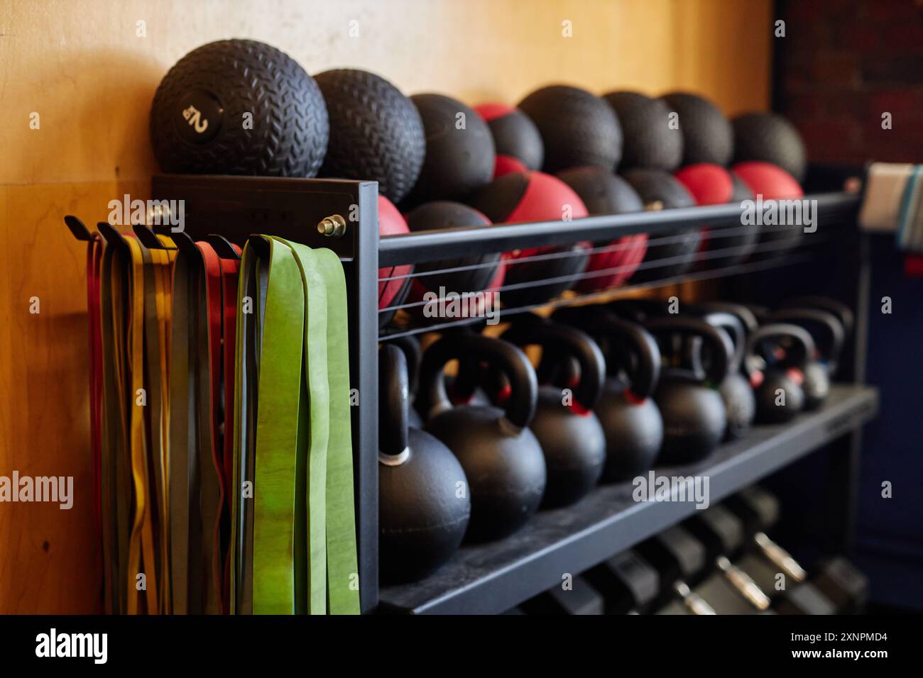 Background image of equipment rack in gym with medballs kettlebells and ...