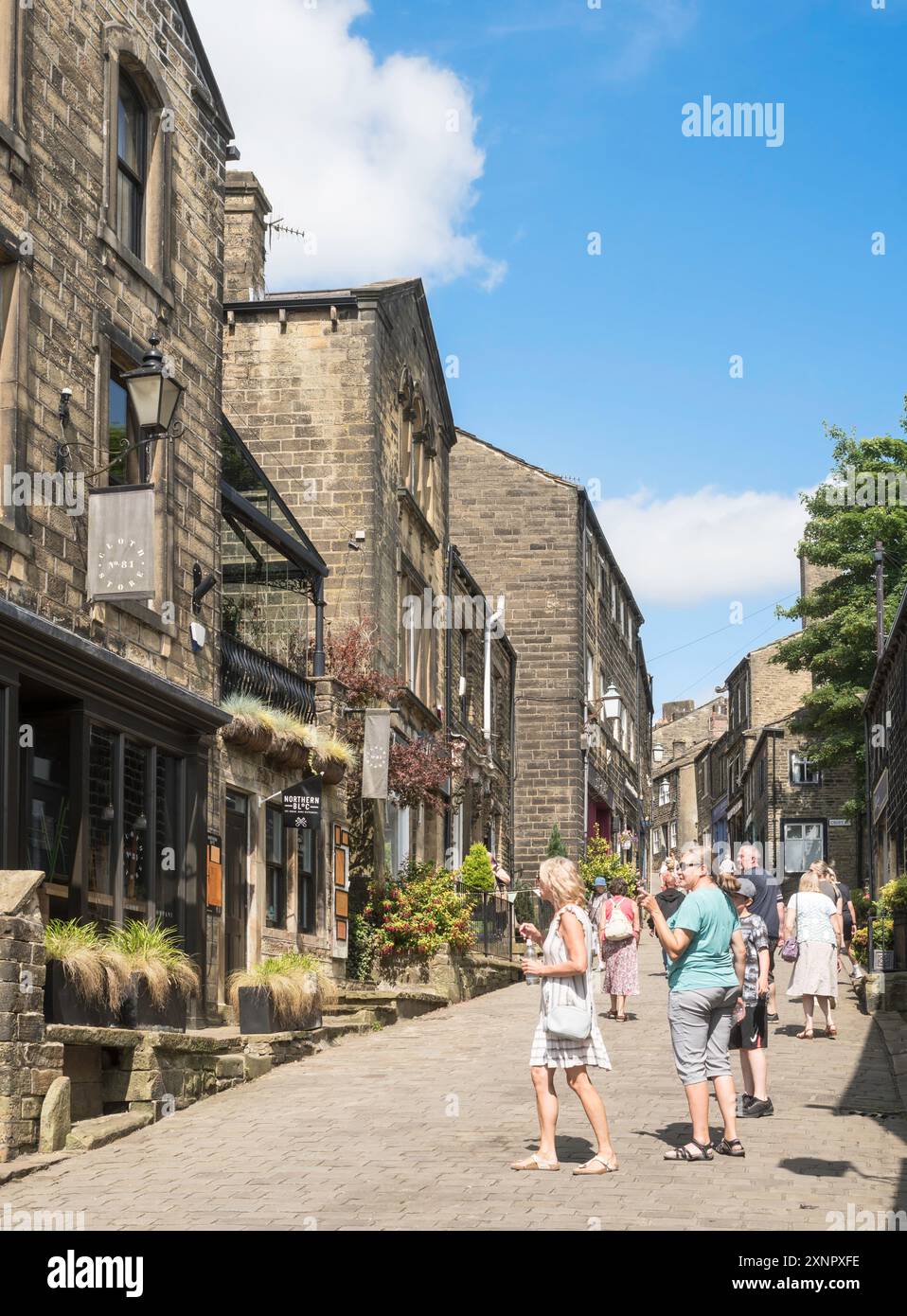 People walking along Howarth Main Street, Yorkshire, England, UK Stock ...